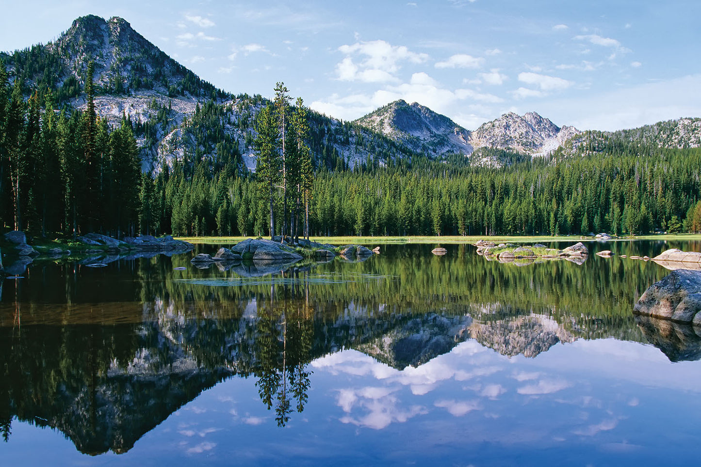 Reflection of the Elkhorn mountain range against blue sky is shown in Anthony Lake in Eastern Oregon.