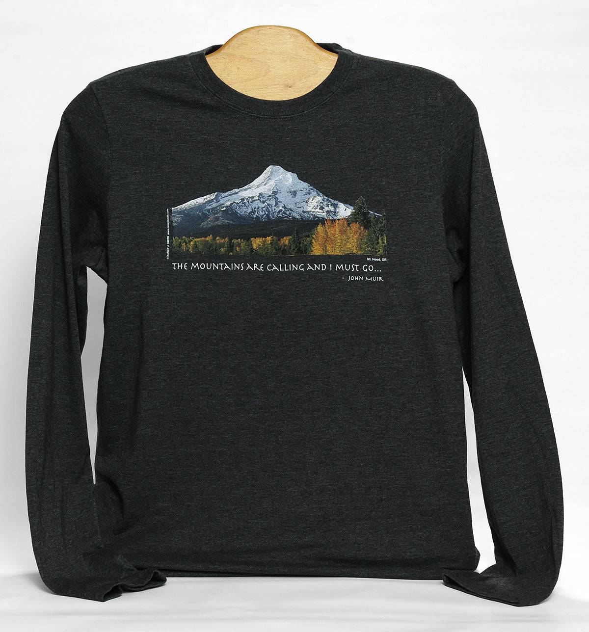 Front view of Mt Hood/Fall long-sleeve crewneck shirt in color dark grey heather. Features Oregon's Mt Hood and fall trees with caption "The Mountains are Calling and I Must Go..."