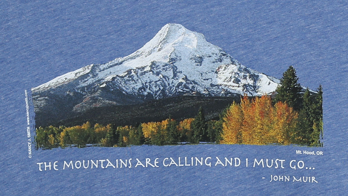 Detail view of shirt print on color blue triblend. Features Oregon's Mt Hood and fall trees with caption "The Mountains are Calling and I Must Go..."