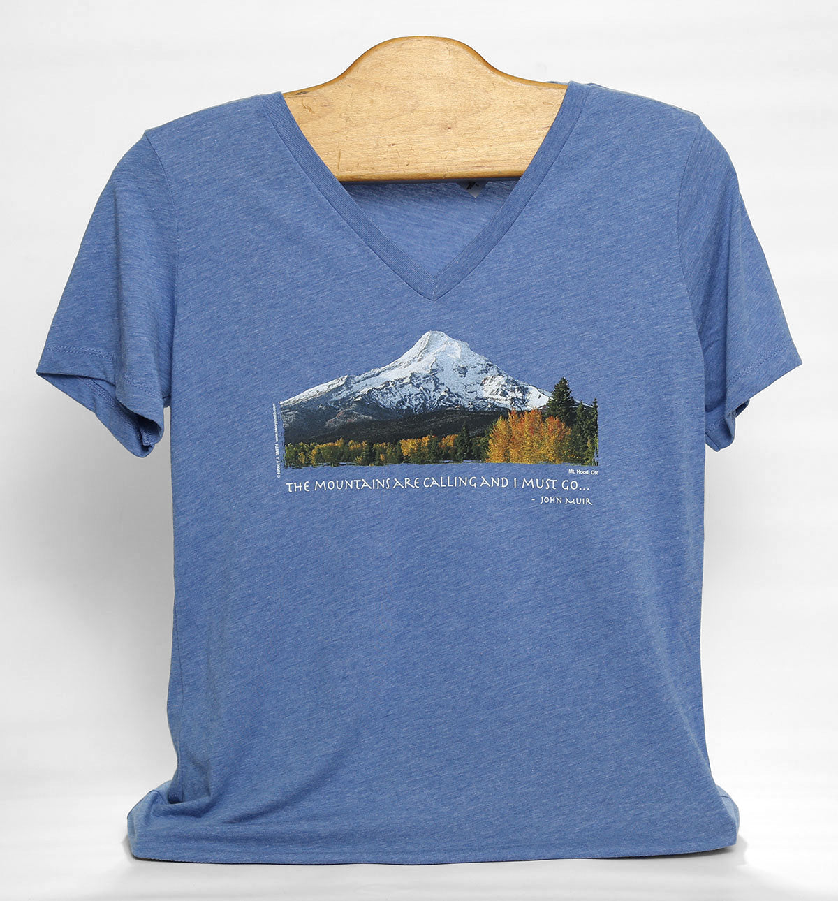 Front view of women's cut Mt Hood/Fall v-neck t-shirt in color blue triblend. Features Oregon's Mt Hood and fall trees with caption "The Mountains are Calling and I Must Go..."