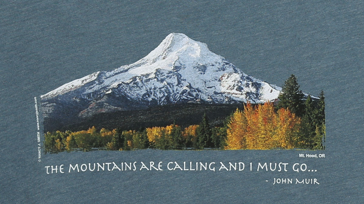 Detail view of shirt print on color heather slate grey. Features Oregon's Mt Hood and fall trees with caption "The Mountains are Calling and I Must Go..."