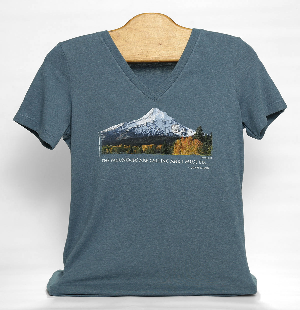 Front view of women's Mt Hood/Fall v-neck short-sleeve t-shirt in color heather slate grey. Features Oregon's Mt Hood and fall trees with caption "The Mountains are Calling and I Must Go..."
