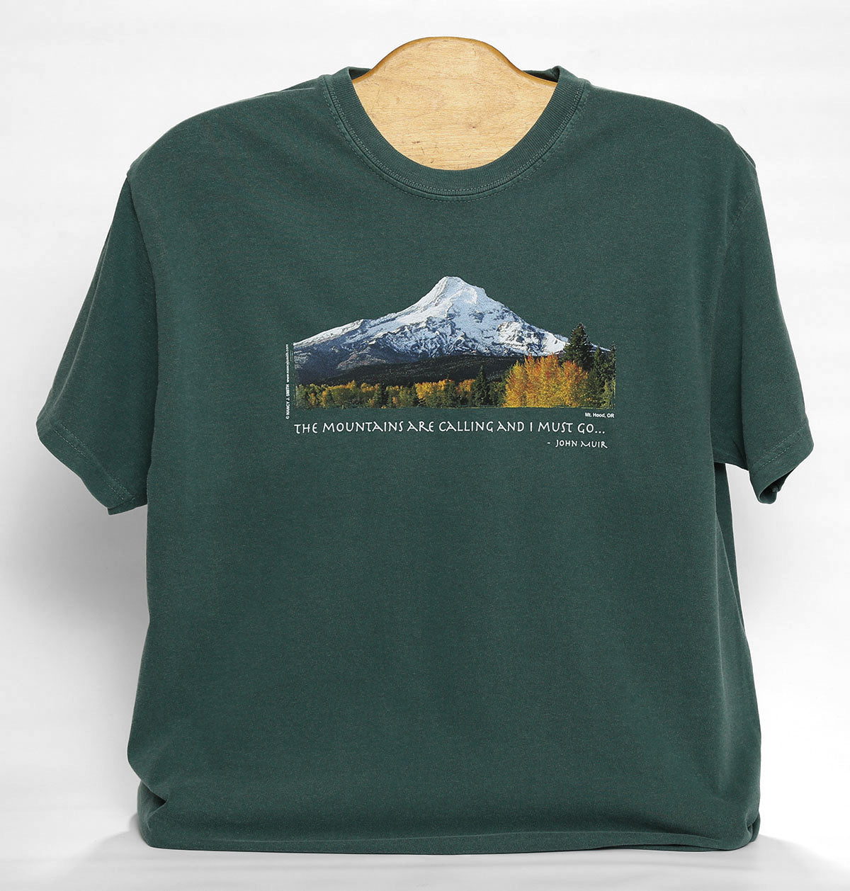 Front view of Mt. Hood/Fall t-shirt in color blue spruce. Features print of Oregon's Mt Hood and fall trees with caption "The Mountains are Calling and I Must Go..."