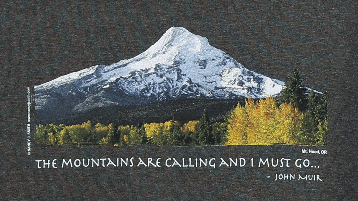 Detail view of shirt print on color tweed dark grey. Features Oregon's Mt Hood and fall trees with caption "The Mountains are Calling and I Must Go..."