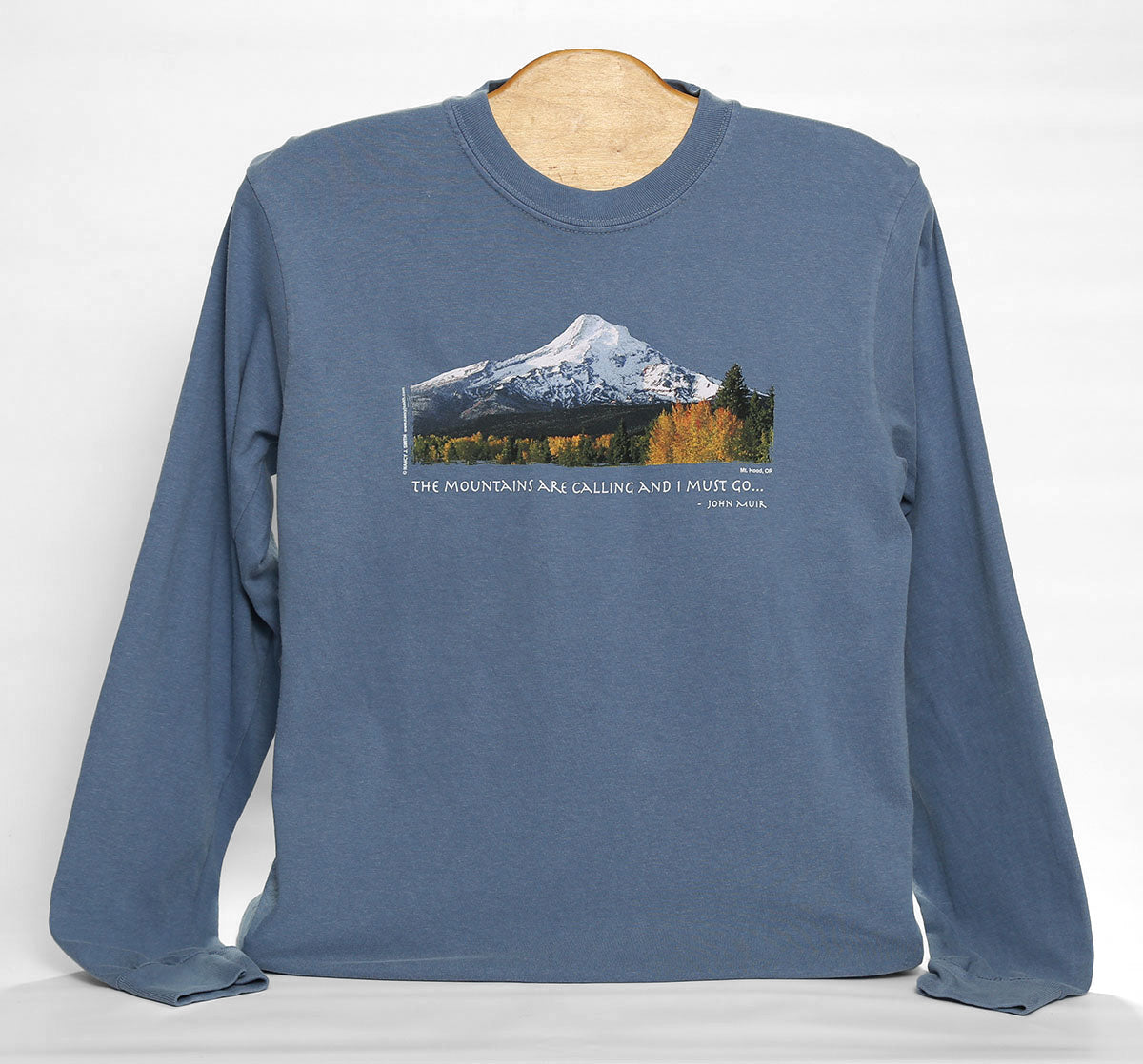 Front view of Mt Hood/Fall Men's long sleeve shirt in color blue jean. Features screen print of Oregon's Mt. Hood with caption "The Mountains are Calling and I Must Go...".