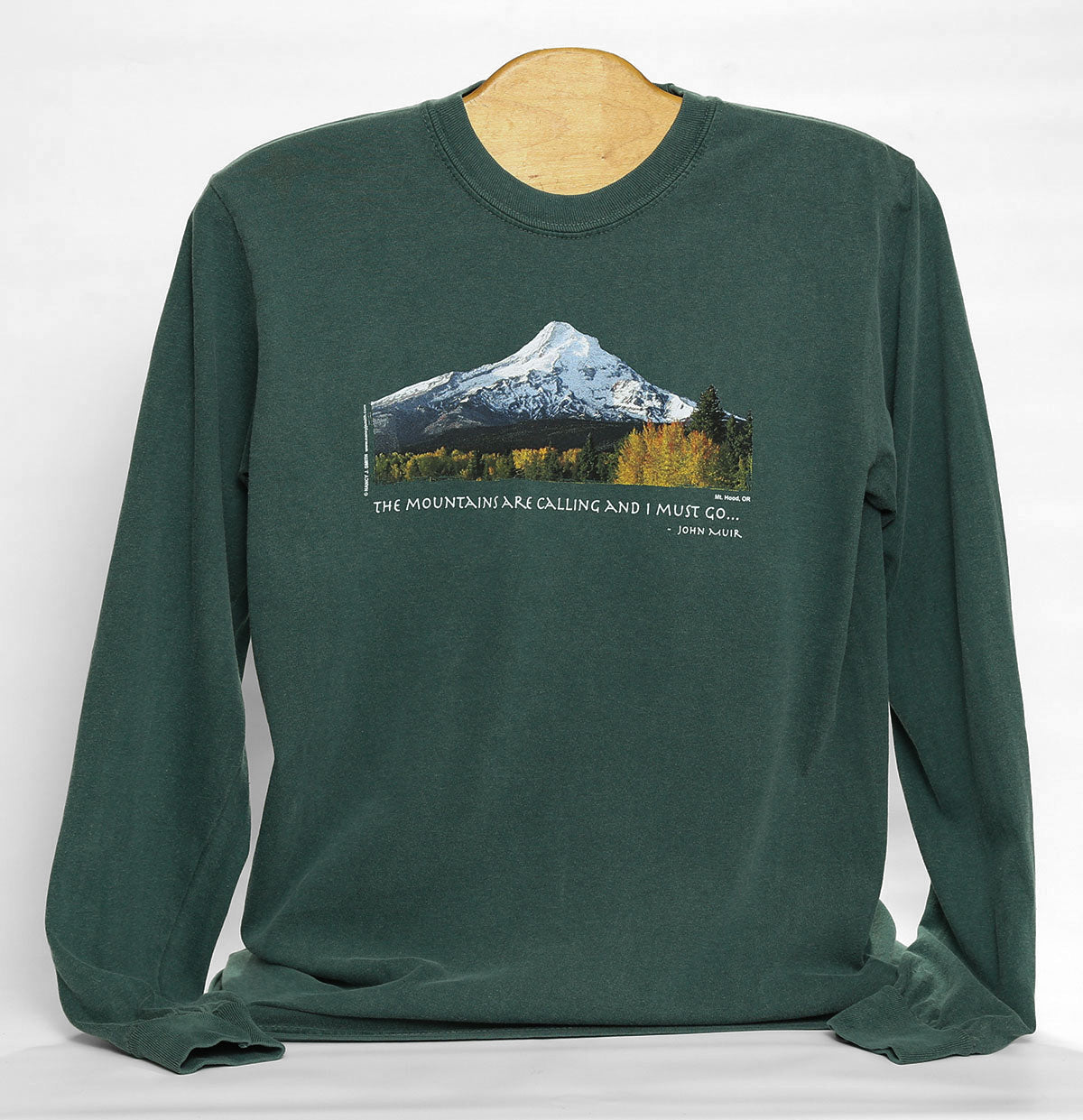 Front view of Mt Hood/Fall long-sleeve t-shirt in color blue spruce green. Features print of Oregon's Mt Hood and fall trees with caption "The Mountains are Calling and I Must Go..."