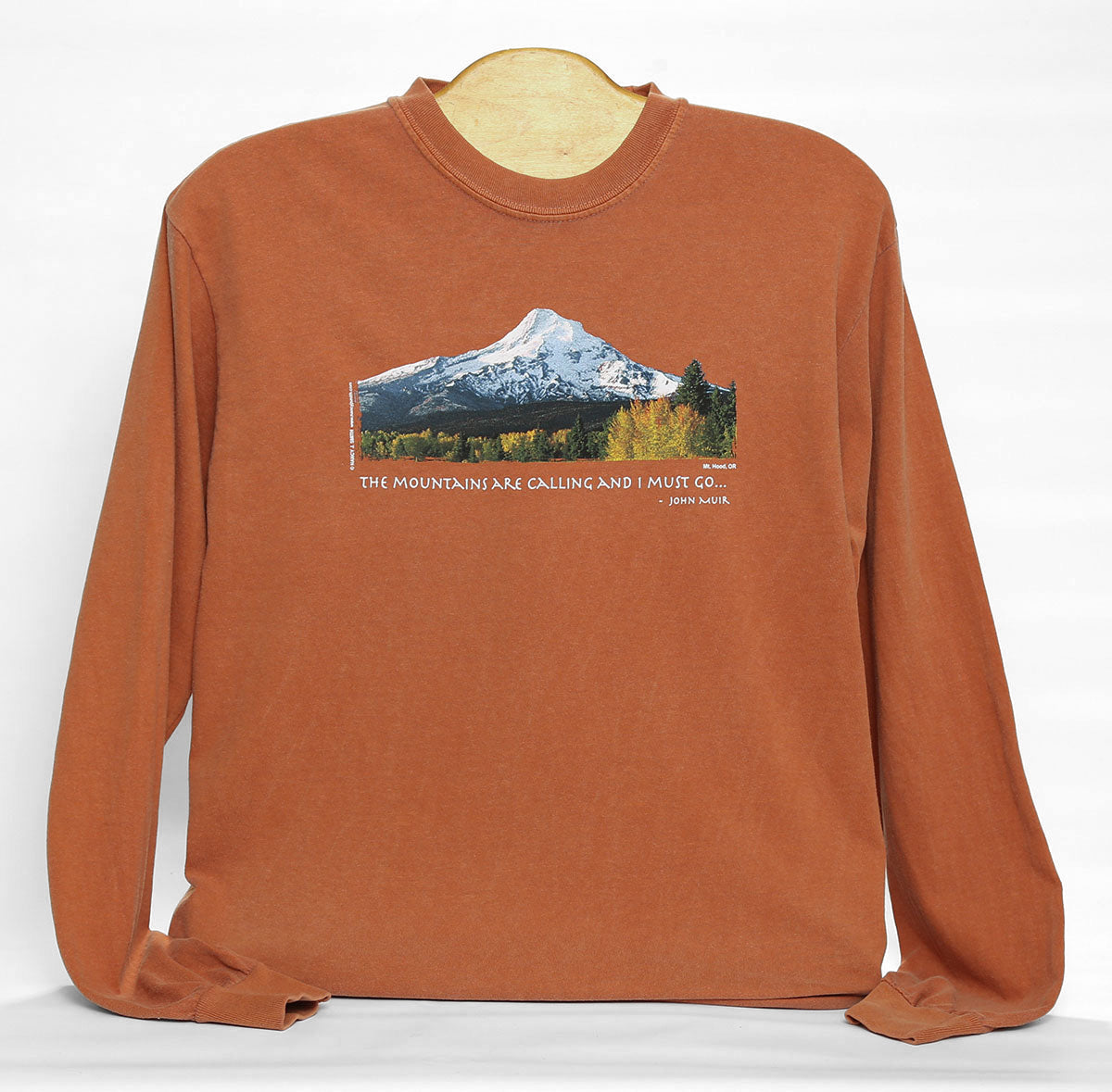 Front view of Mt. Hood/Fall long sleeve t-shirt in color yam orange. Features Oregon's Mt Hood and fall trees with caption "The Mountains are Calling and I Must Go..."
