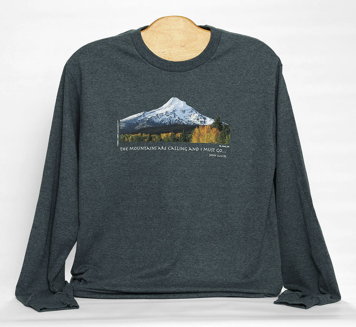 Front view of Mt Hood/Fall long sleeve t-shirt in color dark grey heather. Features print of Oregon's Mt Hood and fall trees with caption "The Mountains are Calling and I Must Go..."