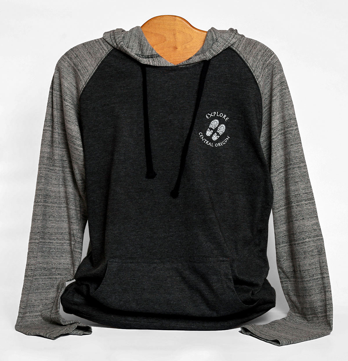 Front view of Three Sisters/Mountains are calling unisex hoodie in color dark grey/stripe. Features icon of two footprints with text "Explore Central Oregon" on chest. Screen printed in Oregon.